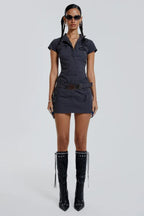 Full-length view of a model in a dark grey short-sleeve collared cargo dress paired with black boots.