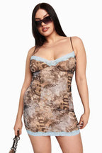 model wearing a brown graphic print mesh mini dress with blue lace trim