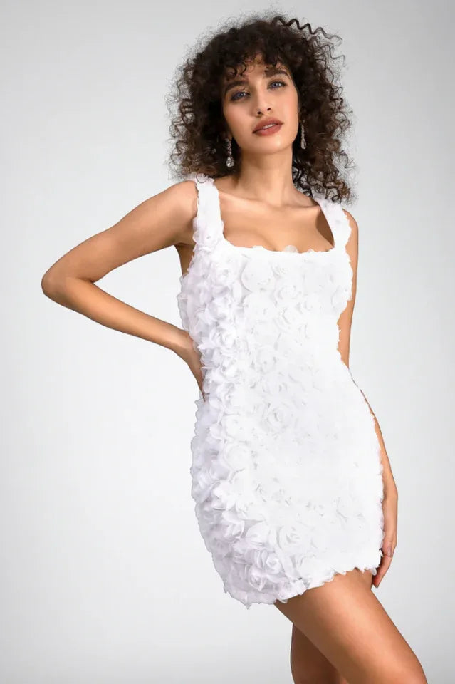 Woman in a white floral mini dress with a square neckline