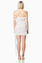 Back view of a white lace mini dress with floral appliques