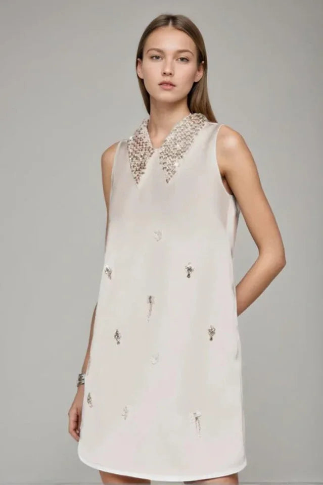 Woman wearing Elif Sleeveless Embellished Mini Dress in white