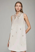 Woman wearing Elif Sleeveless Embellished Mini Dress in white