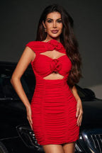 Woman wearing a red ruched mini dress with floral embellishments