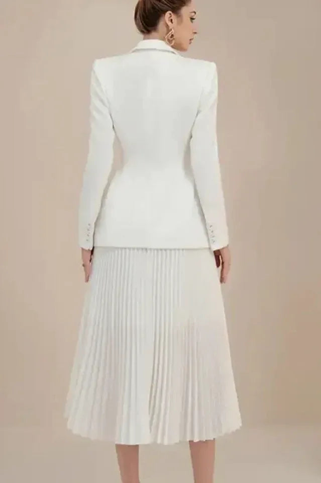 Rear view of a woman in a white pleated midi skirt suit, showcasing the back of the blazer.