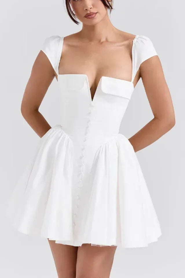 Woman wearing a white fit-and-flare mini dress with a plunging V-neckline and cap sleeves. Main image