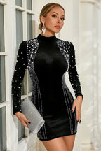 Model wearing a black long sleeve beaded mini dress with a high neck