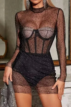 Close-up of rhinestone details on black mesh dress