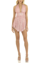 Front view of a woman in a pink sequined halter dress