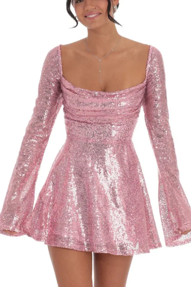 Woman wearing a pink sequined mini dress with long flared sleeves and a scoop neckline