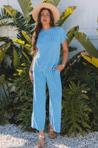Woman wearing a blue ribbed knit short sleeve top and matching wide leg pants