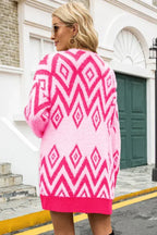 Back view of a woman wearing a pink and white geometric pattern fuzzy knit cardigan.