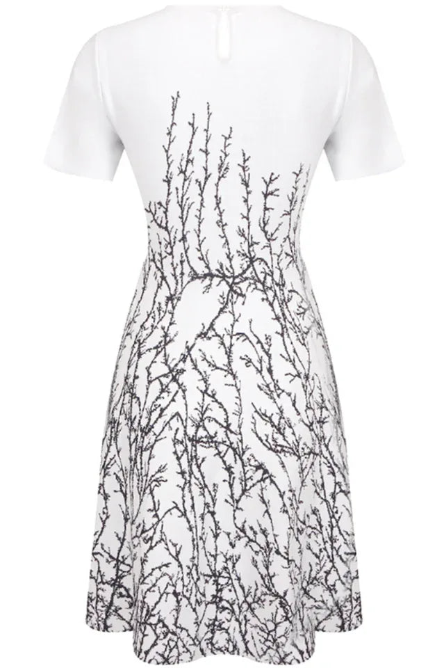 Back view of a white short-sleeve dress with a black branch print