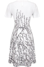 Back view of a white short-sleeve dress with a black branch print