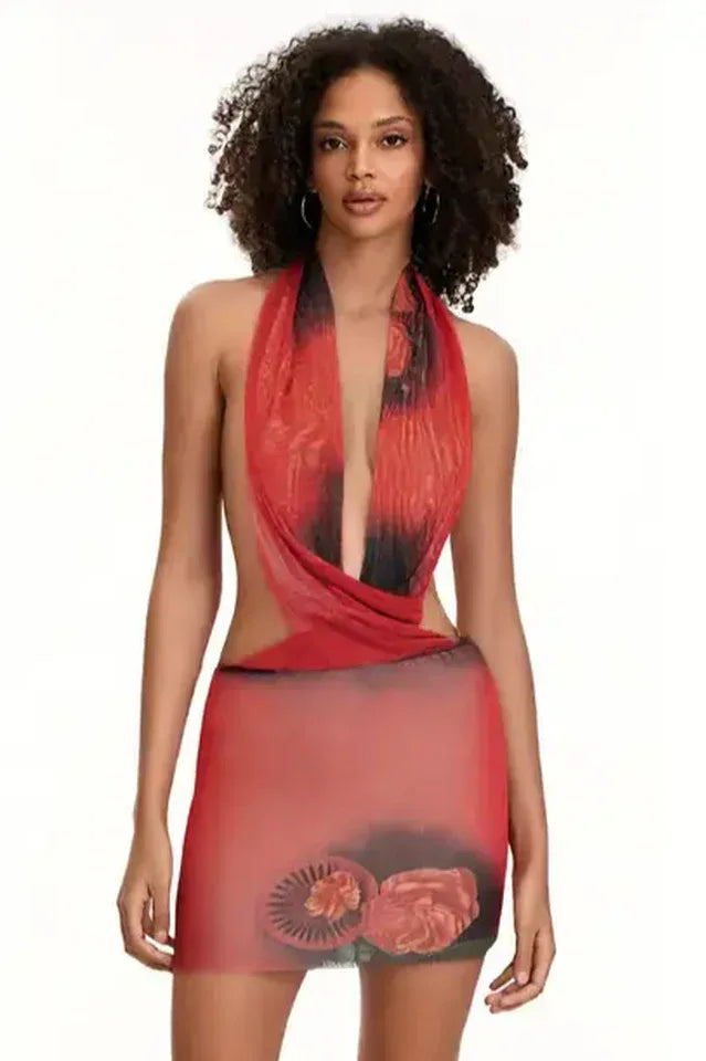 Woman wearing a red and black printed halter mini dress with draped front and cut-out sides Main image