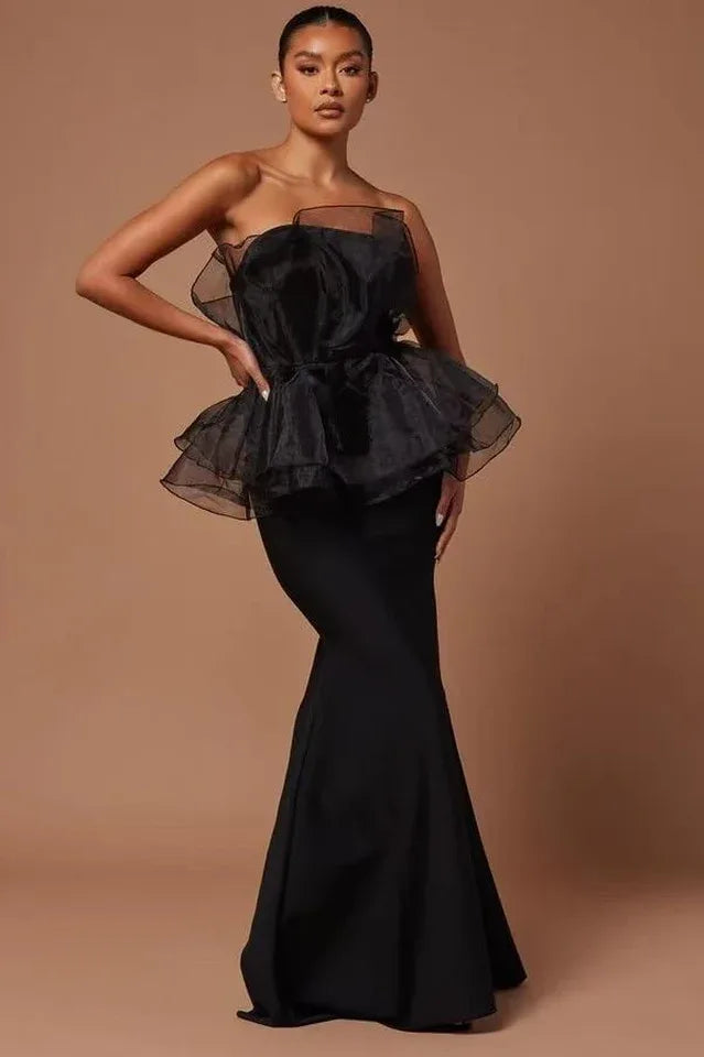 Woman in black strapless formal dress with ruffled organza peplum and mermaid skirt Main image