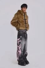 Man wearing a brown faux fur jacket and baggy black jeans with pink tribal print