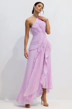 Side view of a woman showcasing a lavender pleated evening gown with a halter neckline and elegant draping.