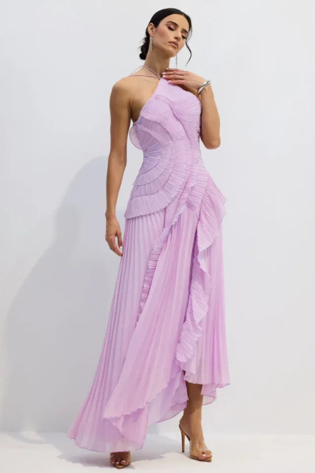 Side view of a woman showcasing a lavender pleated evening gown with a halter neckline and elegant draping.