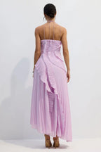 Back view of a lavender pleated maxi dress with a halter neckline and intricate pleat detailing on the bodice and skirt.