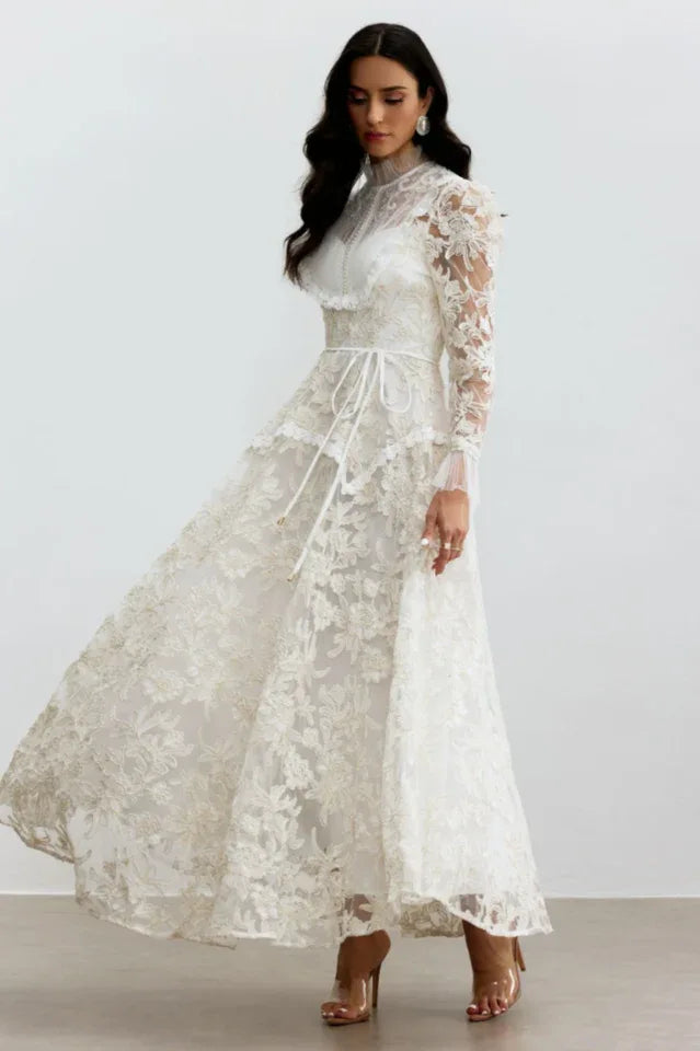 Woman twirling in a flowing white lace A-line gown, showcasing the full skirt.