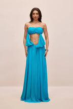 Model posing in a flowing chiffon maxi dress