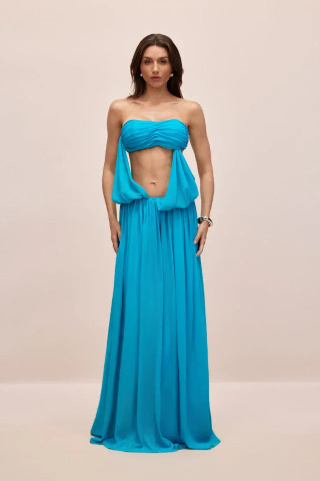 Model posing in a flowing chiffon maxi dress