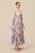 Model posing in an elegant pastel floral print dress with a high neckline and ruffled bell sleeves, highlighting the A-line silhouette.