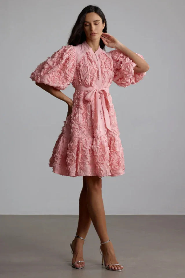 Side view of a woman showcasing the detail of a 3D floral dress