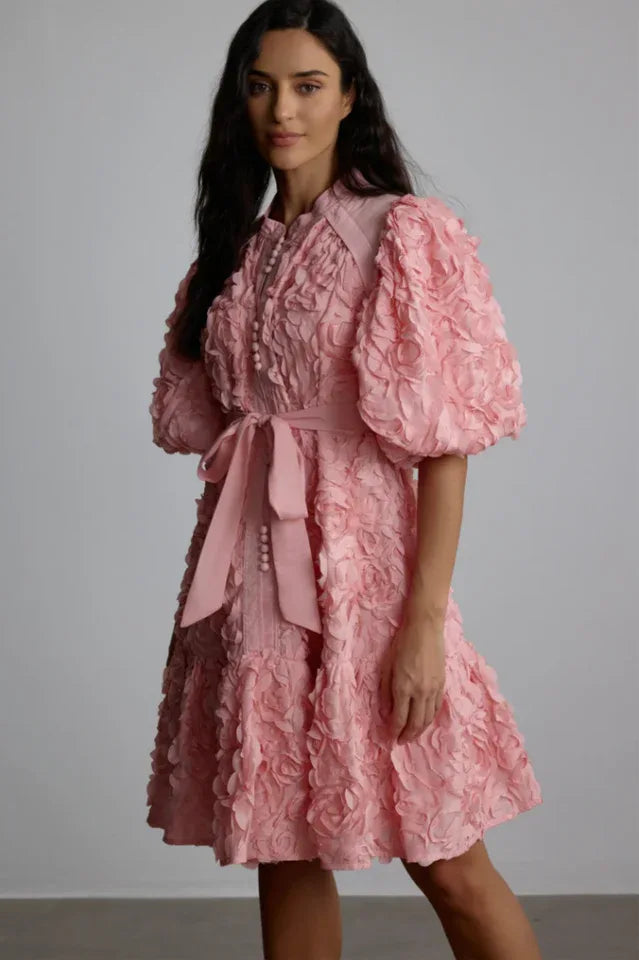 Woman wearing a pink 3D floral puff sleeve mini dress Main image