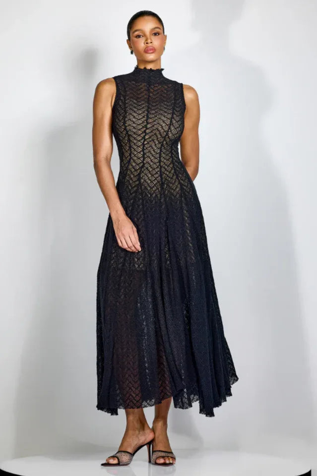 Woman wearing a black sleeveless mock neck A-line knit dress with chevron pattern Main image