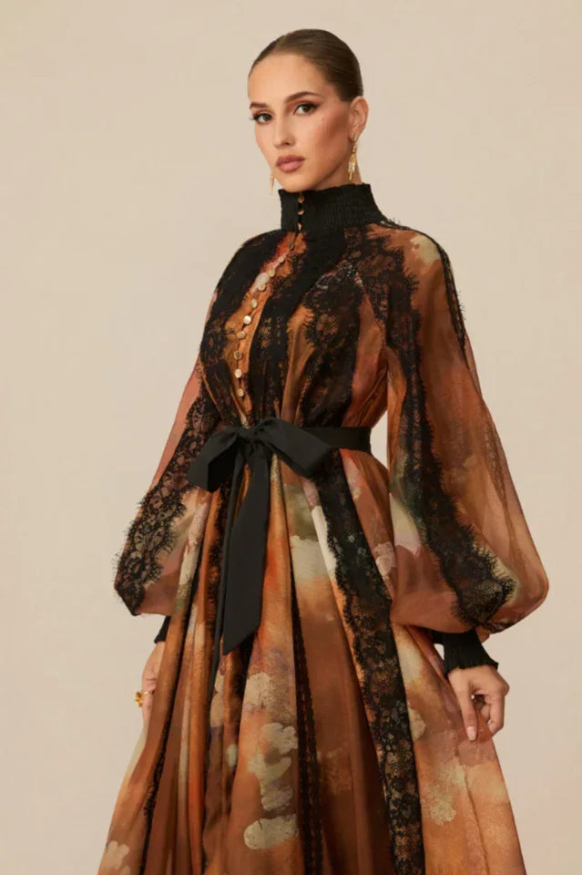 Model showcasing an elegant printed dress with a voluminous silhouette and intricate detailing.