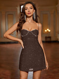 Close-up of a woman wearing a brown embellished mini dress