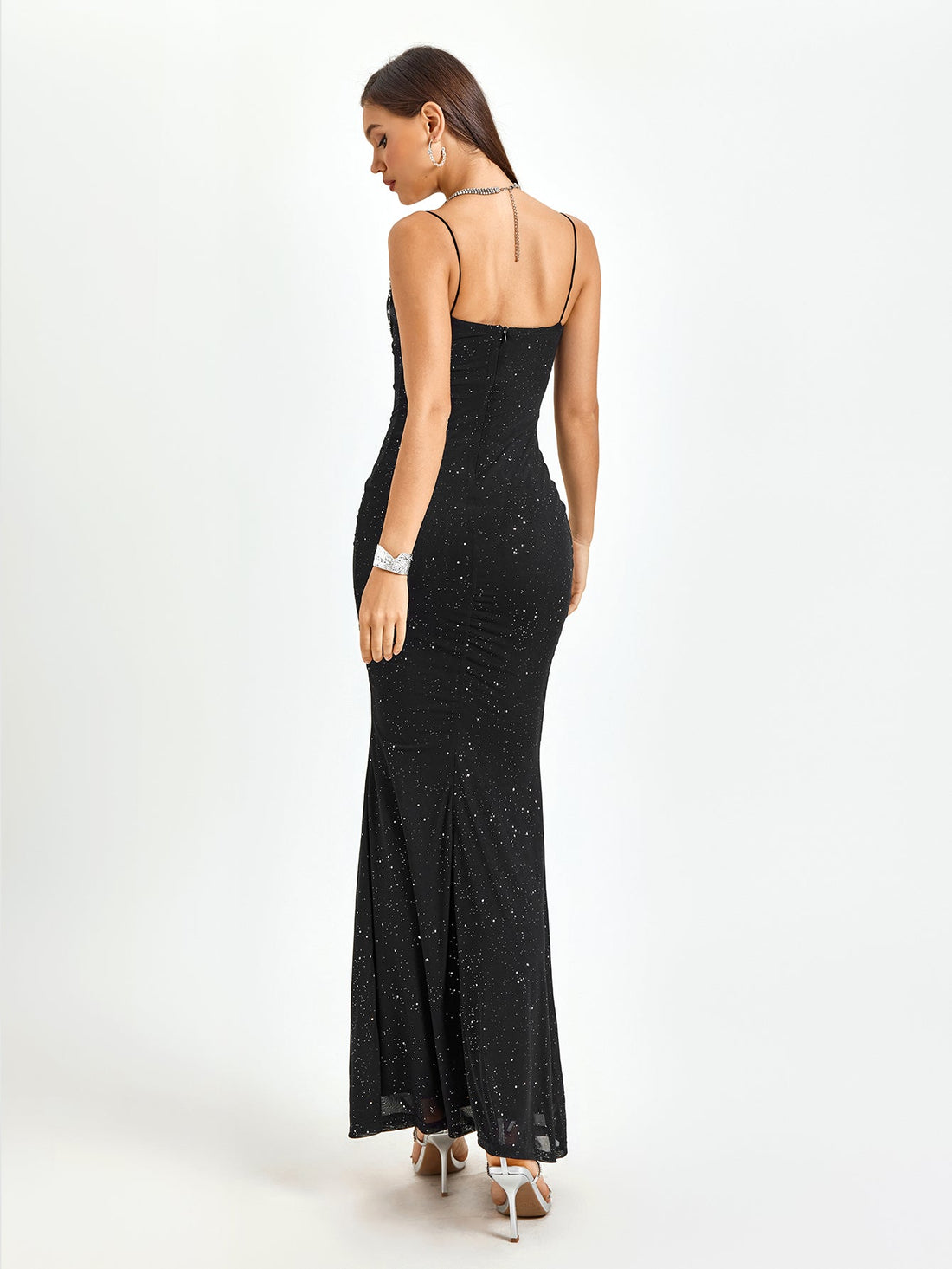Woman wearing a black glittery floor-length mermaid dress with spaghetti straps