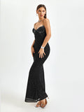 Woman standing in a black glittery floor-length mermaid dress
