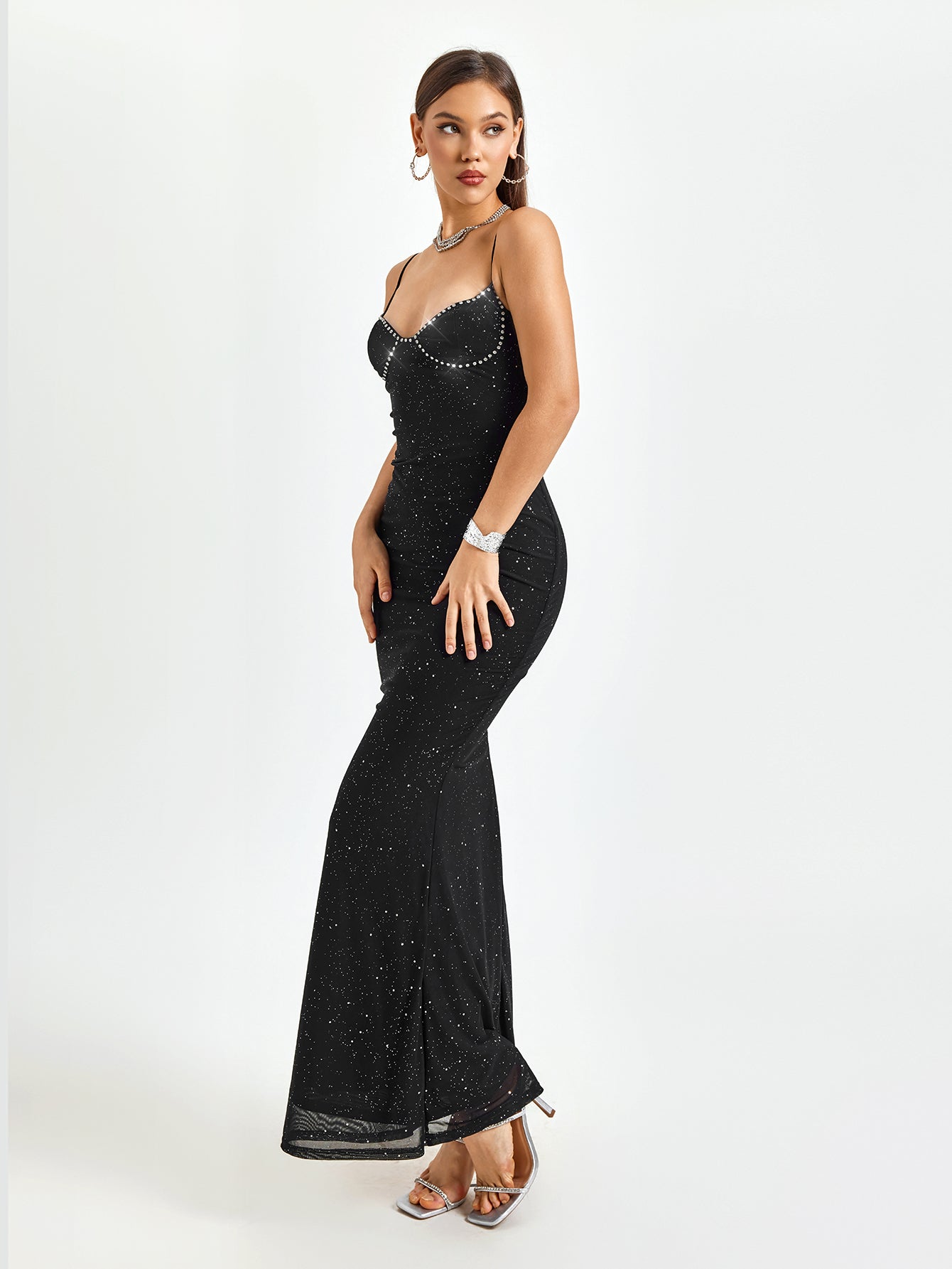 Woman standing in a black glittery floor-length mermaid dress