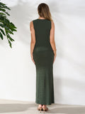 Rear view of a woman wearing a dark green ribbed knit sleeveless collared button-up top and a matching high-waisted column maxi skirt.
