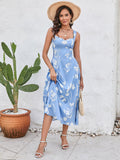 Woman lifting the hem of a blue floral print midi dress, showcasing the midi length.