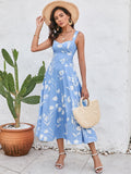 Woman wearing a blue floral print midi dress with a square neckline and spaghetti straps.