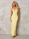 A pale yellow satin formal gown with a plunging neckline and spaghetti straps, presented on a model against a neutral background.