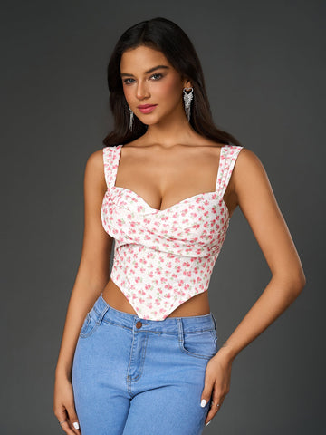 Woman wearing a white floral print cropped top with a sweetheart neckline and wide tank straps.