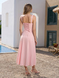 Back view of a woman in a pink midi dress with a lace-up back