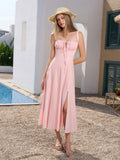 Full body shot of a woman in a pink midi dress outdoors