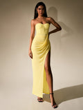 Elegant yellow chiffon dress with a corset top and a flowing skirt, featuring a bold side slit.