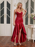Woman posing in a red satin formal dress with ruffle accent