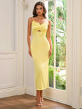 Model in a yellow satin sheath dress with a V-neckline and cut-out waist detail.