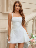 Woman in a white button front ruched dress posing outdoors