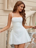 Woman in a white ruched spaghetti strap dress with button front detail