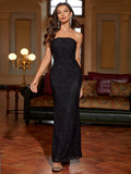 Woman wearing a black strapless sequined mermaid evening gown, front view