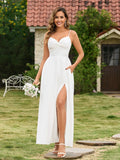 Full body shot of a woman in a white formal dress with side pockets, posing outdoors.