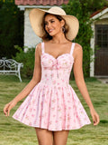 Woman wearing a pink floral print mini dress and a straw hat, outdoors
